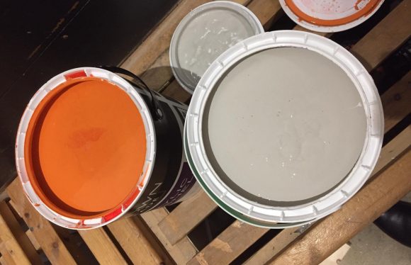 Tins of orange and grey paint used at Community Project at Sidney Park JFC